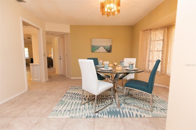 238 Mark Twain Ln, Rotonda West, FL 33947 - tiled dining room with a chandelier and baseboards