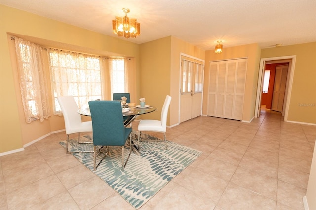 238 Mark Twain Ln, Rotonda West, FL 33947 - dining area featuring a chandelier, tile patterned flooring, and baseboards