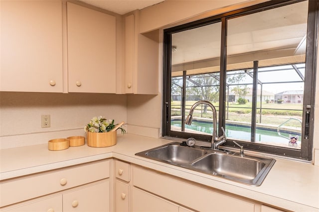 238 Mark Twain Ln, Rotonda West, FL 33947 - kitchen with a sink, light countertops, and white cabinets