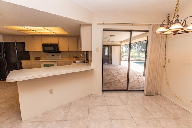 238 Mark Twain Ln, Rotonda West, FL 33947 - kitchen featuring black appliances, light countertops, a chandelier, a sink, and a peninsula