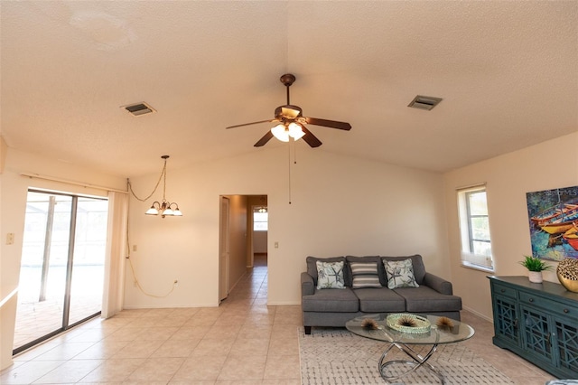 238 Mark Twain Ln, Rotonda West, FL 33947 - living room with plenty of natural light, a ceiling fan, lofted ceiling, a chandelier, and light tile patterned floors
