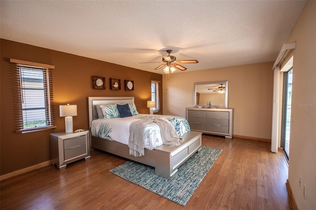 238 Mark Twain Ln, Rotonda West, FL 33947 - bedroom featuring wood finished floors, baseboards, a textured ceiling, and ceiling fan