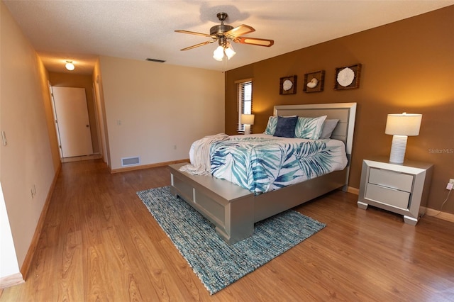 238 Mark Twain Ln, Rotonda West, FL 33947 - bedroom with light wood-type flooring, baseboards, and a ceiling fan