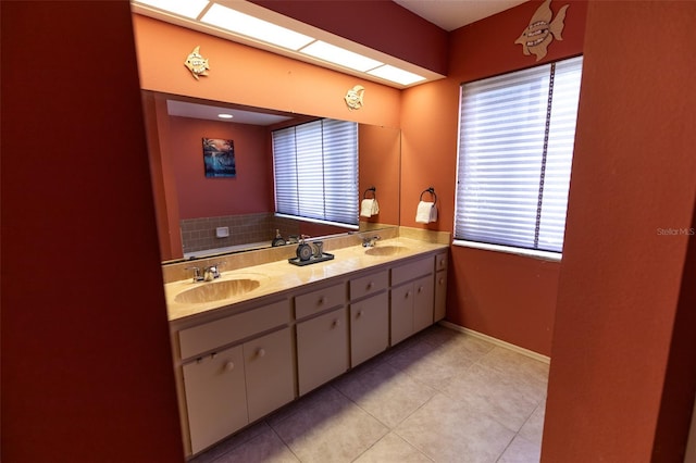 238 Mark Twain Ln, Rotonda West, FL 33947 - bathroom featuring double vanity, tile patterned floors, and baseboards