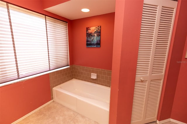 238 Mark Twain Ln, Rotonda West, FL 33947 - bathroom with a closet, tile patterned floors, a garden tub, and baseboards