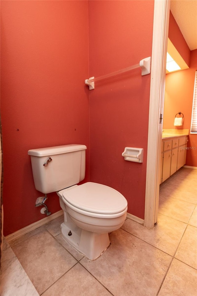 238 Mark Twain Ln, Rotonda West, FL 33947 - bathroom with toilet, tile patterned floors, vanity, and baseboards