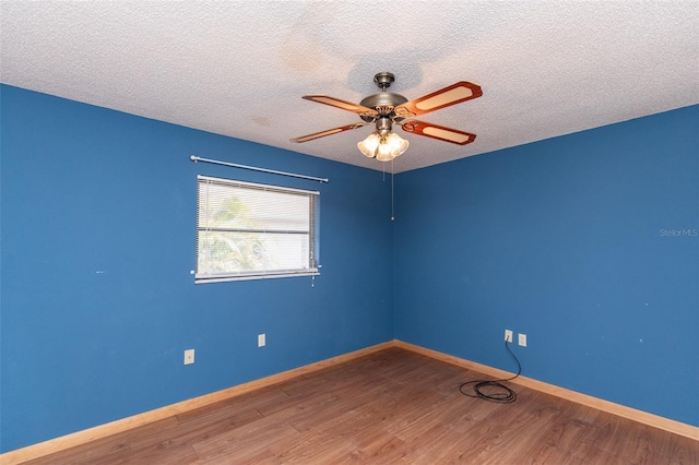 238 Mark Twain Ln, Rotonda West, FL 33947 - unfurnished room with wood finished floors, a ceiling fan, a textured ceiling, and baseboards