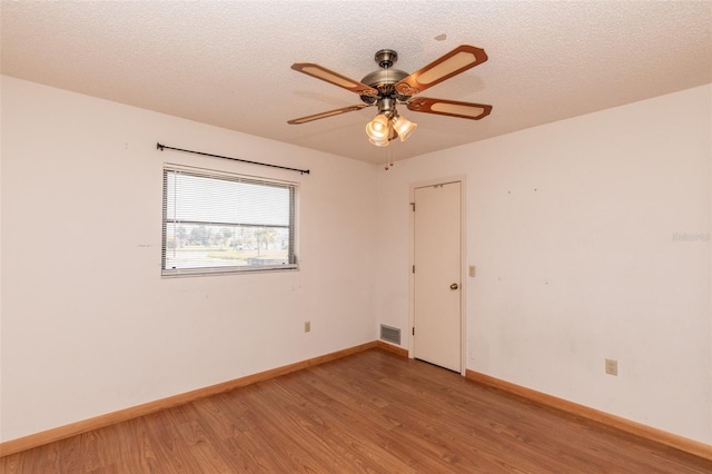 238 Mark Twain Ln, Rotonda West, FL 33947 - unfurnished room featuring light wood-style floors, baseboards, a ceiling fan, and a textured ceiling
