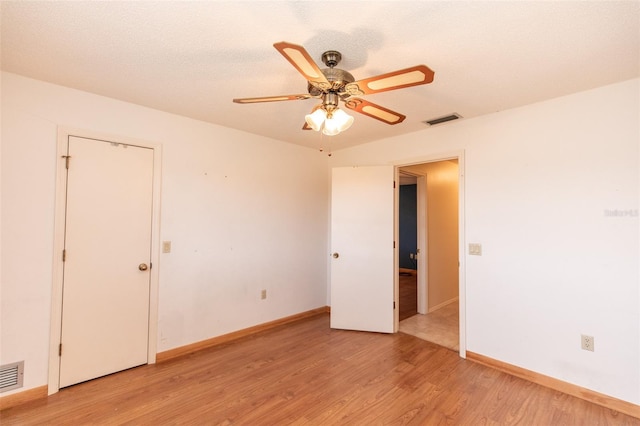 238 Mark Twain Ln, Rotonda West, FL 33947 - spare room featuring light wood-style flooring, a ceiling fan, and baseboards