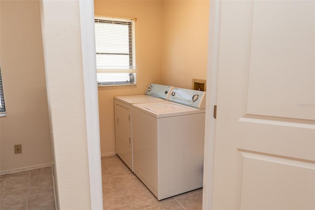 238 Mark Twain Ln, Rotonda West, FL 33947 - laundry room with washer and clothes dryer and light tile patterned floors
