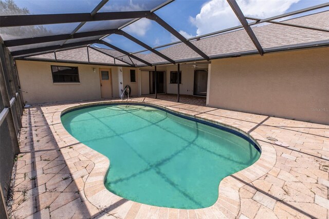 238 Mark Twain Ln, Rotonda West, FL 33947 - outdoor pool featuring a patio and glass enclosure