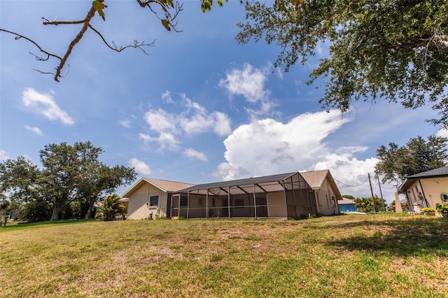 238 Mark Twain Ln, Rotonda West, FL 33947 - rear view of house featuring a lawn and glass enclosure