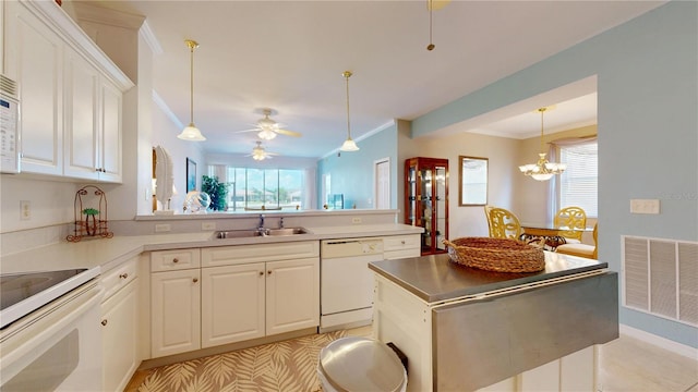 2002 Bal Harbor Blvd Unit 1712, Punta Gorda, FL 33950 - kitchen with white appliances, a sink, white cabinets, ornamental molding, and pendant lighting