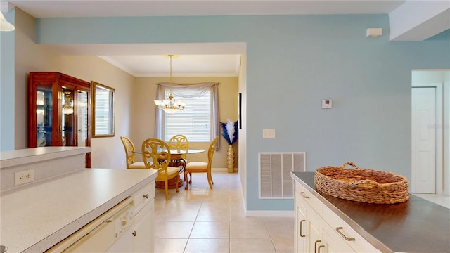 2002 Bal Harbor Blvd Unit 1712, Punta Gorda, FL 33950 - kitchen with a chandelier, baseboards, decorative light fixtures, light tile patterned floors, and white cabinetry