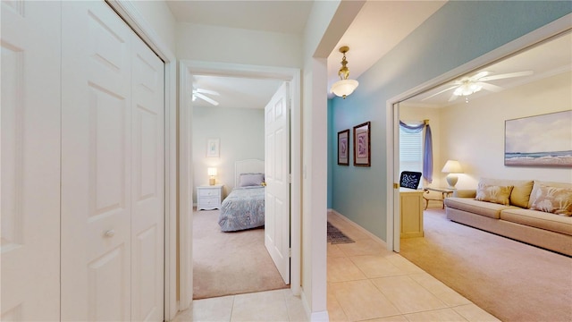 2002 Bal Harbor Blvd Unit 1712, Punta Gorda, FL 33950 - hall with light carpet, light tile patterned floors, and baseboards