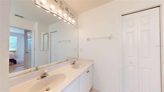 2002 Bal Harbor Blvd Unit 1712, Punta Gorda, FL 33950 - ensuite bathroom featuring a closet, double vanity, and baseboards