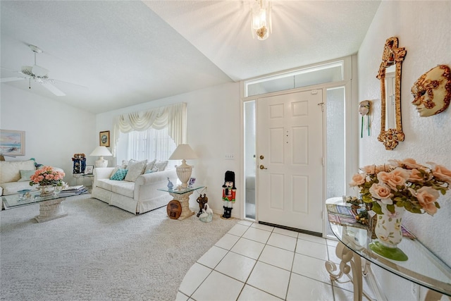 4055 Alwick Ln, North Port, FL 34287 - foyer featuring light carpet, a ceiling fan, lofted ceiling, and light tile patterned flooring