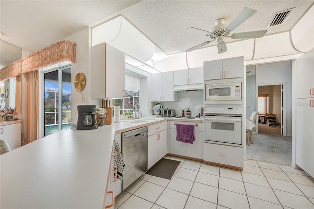 4055 Alwick Ln, North Port, FL 34287 - kitchen with white appliances, light countertops, a sink, a ceiling fan, and under cabinet range hood