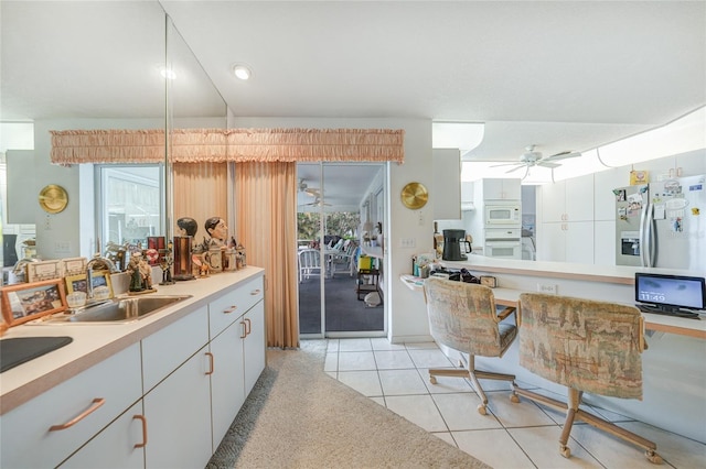 4055 Alwick Ln, North Port, FL 34287 - kitchen featuring white appliances, a sink, a ceiling fan, light countertops, and light tile patterned flooring