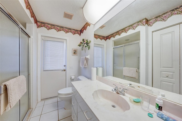4055 Alwick Ln, North Port, FL 34287 - full bathroom featuring vanity, toilet, a shower stall, tile patterned floors, and a textured ceiling