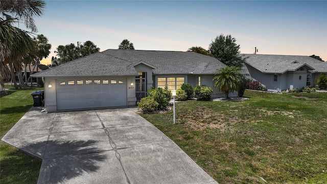 4055 Alwick Ln, North Port, FL 34287 - single story home featuring driveway, an attached garage, a lawn, stucco siding, and a shingled roof