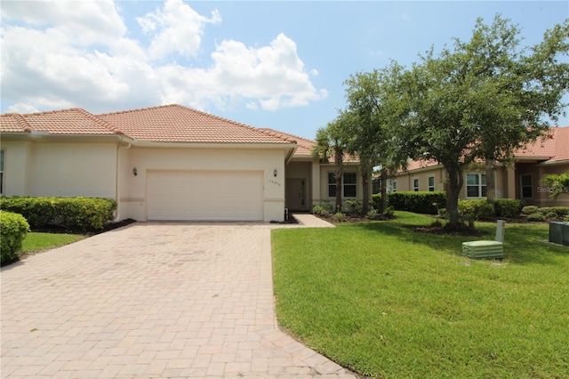 13256 Creekside Ln, Port Charlotte, FL 33953 - view of front facade with decorative driveway, an attached garage, a tile roof, a front yard, and stucco siding
