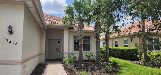13256 Creekside Ln, Port Charlotte, FL 33953 - entrance to property featuring stucco siding and a tiled roof