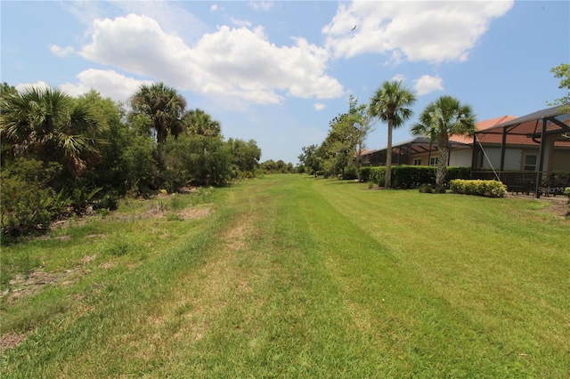 13256 Creekside Ln, Port Charlotte, FL 33953 - view of grassy yard featuring a lanai