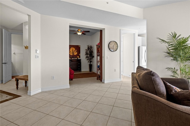 99 Vivante Blvd Unit 303, Punta Gorda, FL 33950 - living area with light tile patterned floors, a ceiling fan, and baseboards