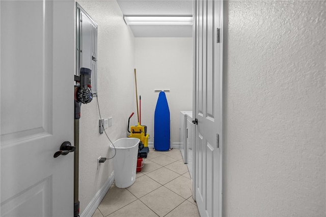 99 Vivante Blvd Unit 303, Punta Gorda, FL 33950 - hallway with light tile patterned floors, a textured wall, and baseboards