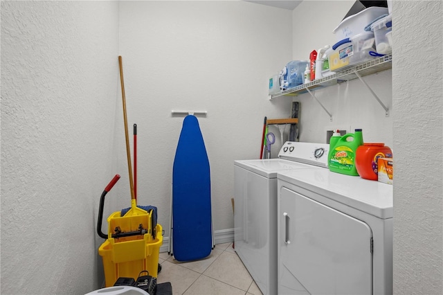 99 Vivante Blvd Unit 303, Punta Gorda, FL 33950 - washroom featuring washing machine and clothes dryer, light tile patterned floors, and a textured wall