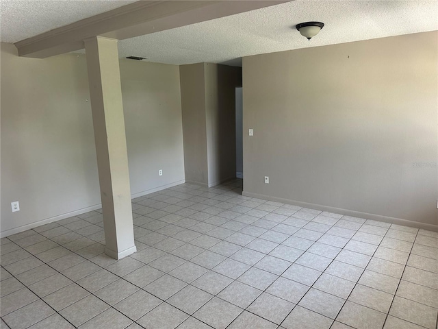 708 N Johnson Ave, Arcadia, FL 34266 - spare room with a textured ceiling, light tile patterned floors, and baseboards