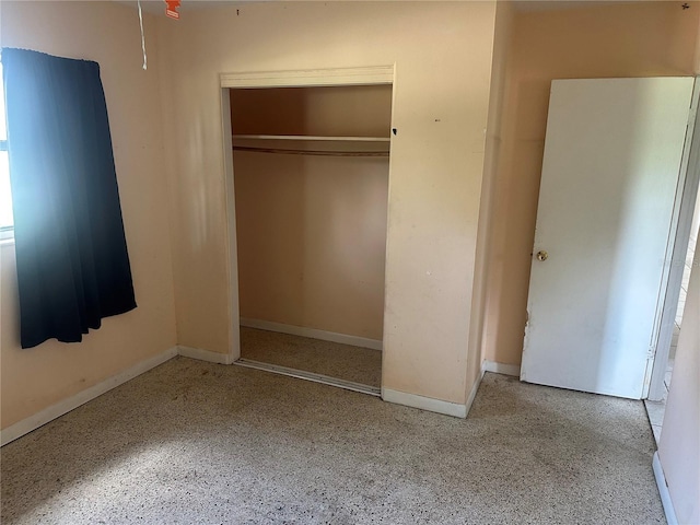 708 N Johnson Ave, Arcadia, FL 34266 - unfurnished bedroom featuring a closet, speckle patterned floor, and baseboards