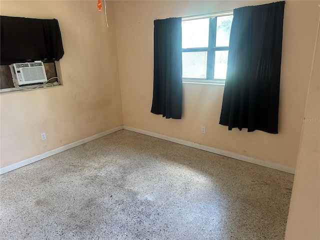 708 N Johnson Ave, Arcadia, FL 34266 - unfurnished room with speckled floor, cooling unit, and baseboards