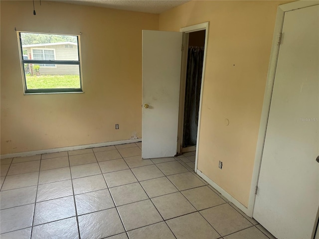 708 N Johnson Ave, Arcadia, FL 34266 - unfurnished bedroom with light tile patterned floors and baseboards