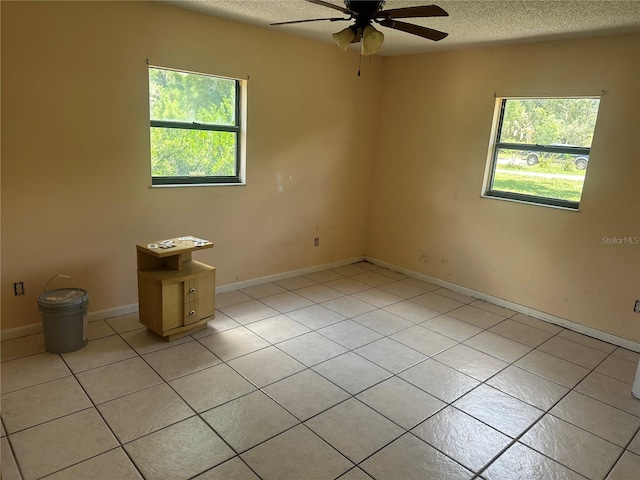 708 N Johnson Ave, Arcadia, FL 34266 - unfurnished room with a ceiling fan, light tile patterned floors, a textured ceiling, and baseboards