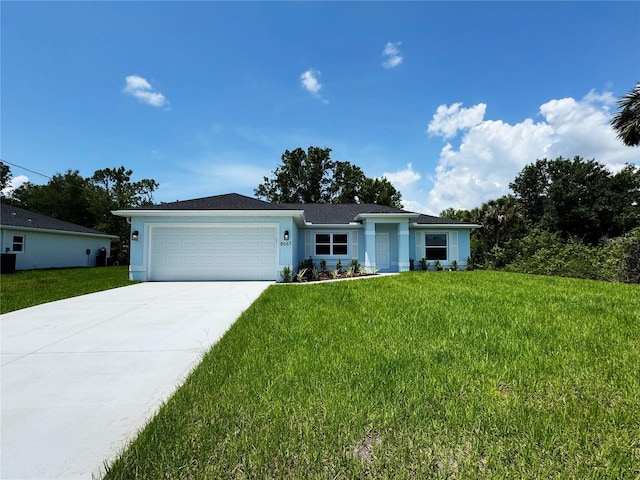 8667 Lisa Blvd, North Port, FL 34288 - ranch-style home featuring driveway, a garage, a front lawn, and stucco siding