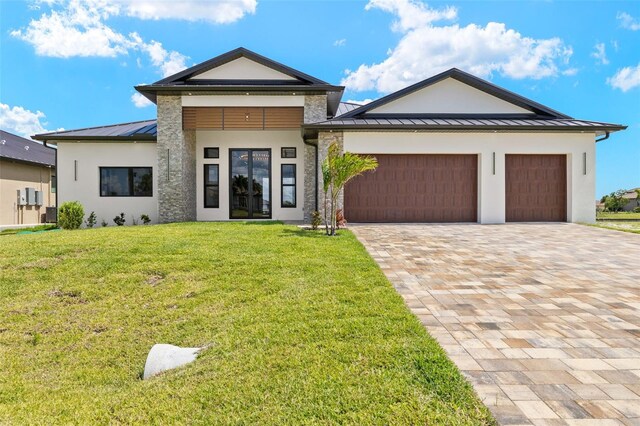 3413 NW 9th Ter, Cape Coral, FL 33904 - view of front of property with a standing seam roof, a garage, stucco siding, and metal roof