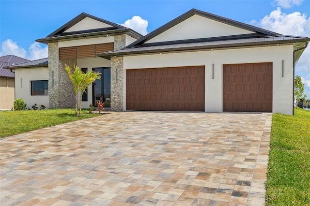 3413 NW 9th Ter, Cape Coral, FL 33904 - view of front of property featuring stucco siding, an attached garage, a front yard, a standing seam roof, and decorative driveway