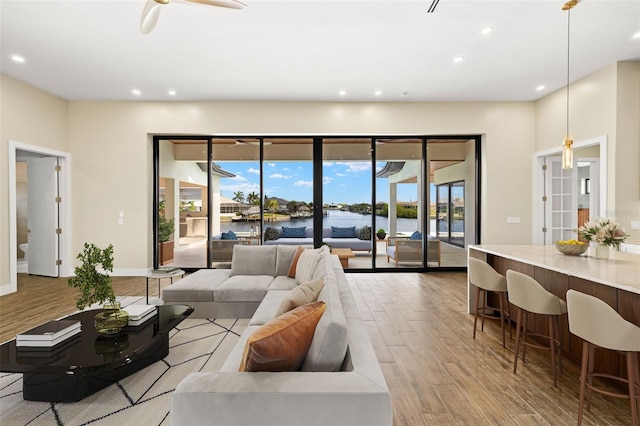 3413 NW 9th Ter, Cape Coral, FL 33904 - living room with wood finished floors, recessed lighting, healthy amount of natural light, a water view, and a ceiling fan