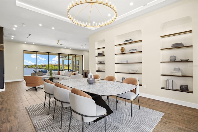 3413 NW 9th Ter, Cape Coral, FL 33904 - dining space featuring wood finished floors, recessed lighting, baseboards, a tray ceiling, and built in features
