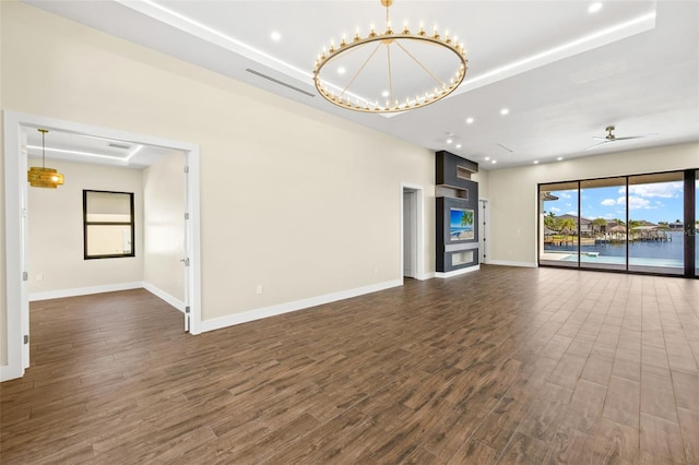 3413 NW 9th Ter, Cape Coral, FL 33904 - unfurnished living room featuring dark wood-style flooring, recessed lighting, baseboards, a chandelier, and a ceiling fan