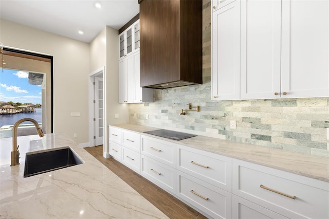 3413 NW 9th Ter, Cape Coral, FL 33904 - kitchen with a sink, black electric cooktop, backsplash, white cabinets, and recessed lighting
