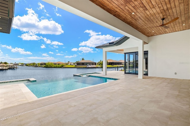 3413 NW 9th Ter, Cape Coral, FL 33904 - view of pool with a water view, a ceiling fan, a pool with connected hot tub, and a patio area