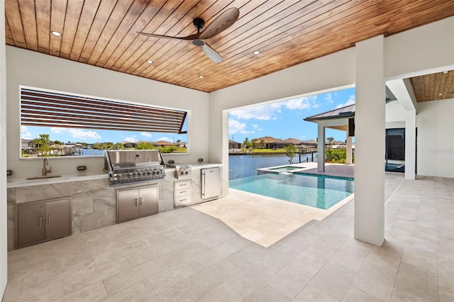 3413 NW 9th Ter, Cape Coral, FL 33904 - view of swimming pool featuring a sink, a ceiling fan, a pool with connected hot tub, a patio, and a water view