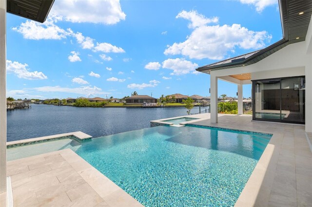 3413 NW 9th Ter, Cape Coral, FL 33904 - view of pool with a patio area, a water view, a residential view, and a pool with connected hot tub