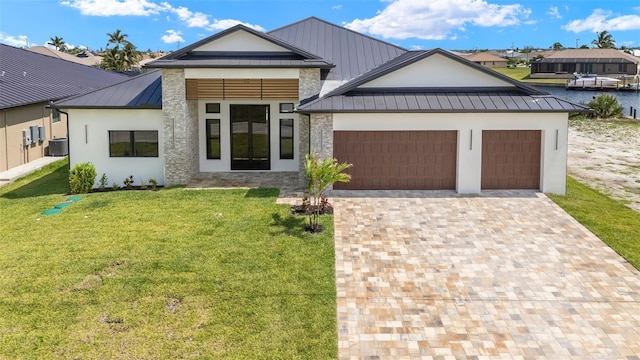 3413 NW 9th Ter, Cape Coral, FL 33904 - modern home featuring a standing seam roof, a garage, metal roof, a front lawn, and central AC