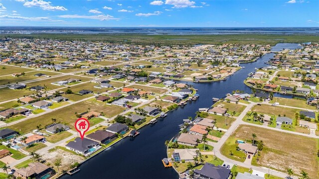 3413 NW 9th Ter, Cape Coral, FL 33904 - aerial view of property and surrounding area with nearby suburban area and a large body of water