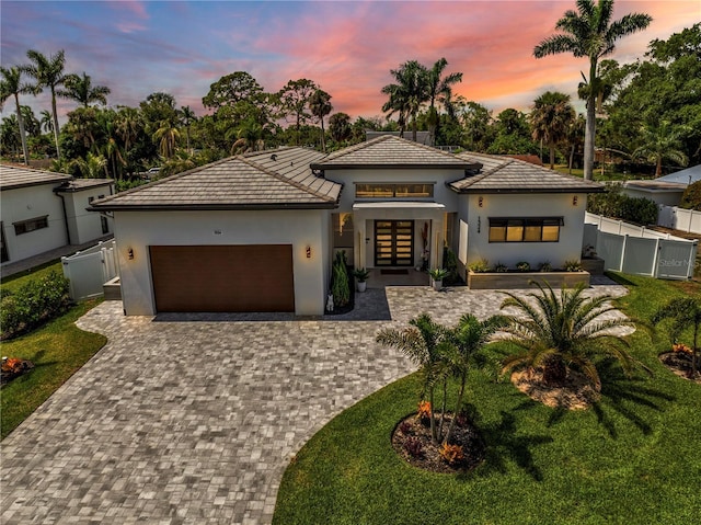 1324 Longwood Dr, Fort Myers, FL 33919 - view of front of property featuring french doors, an attached garage, stucco siding, driveway, and a tile roof
