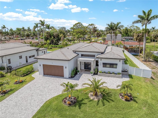 1324 Longwood Dr, Fort Myers, FL 33919 - contemporary house with a garage, decorative driveway, stucco siding, and a tiled roof